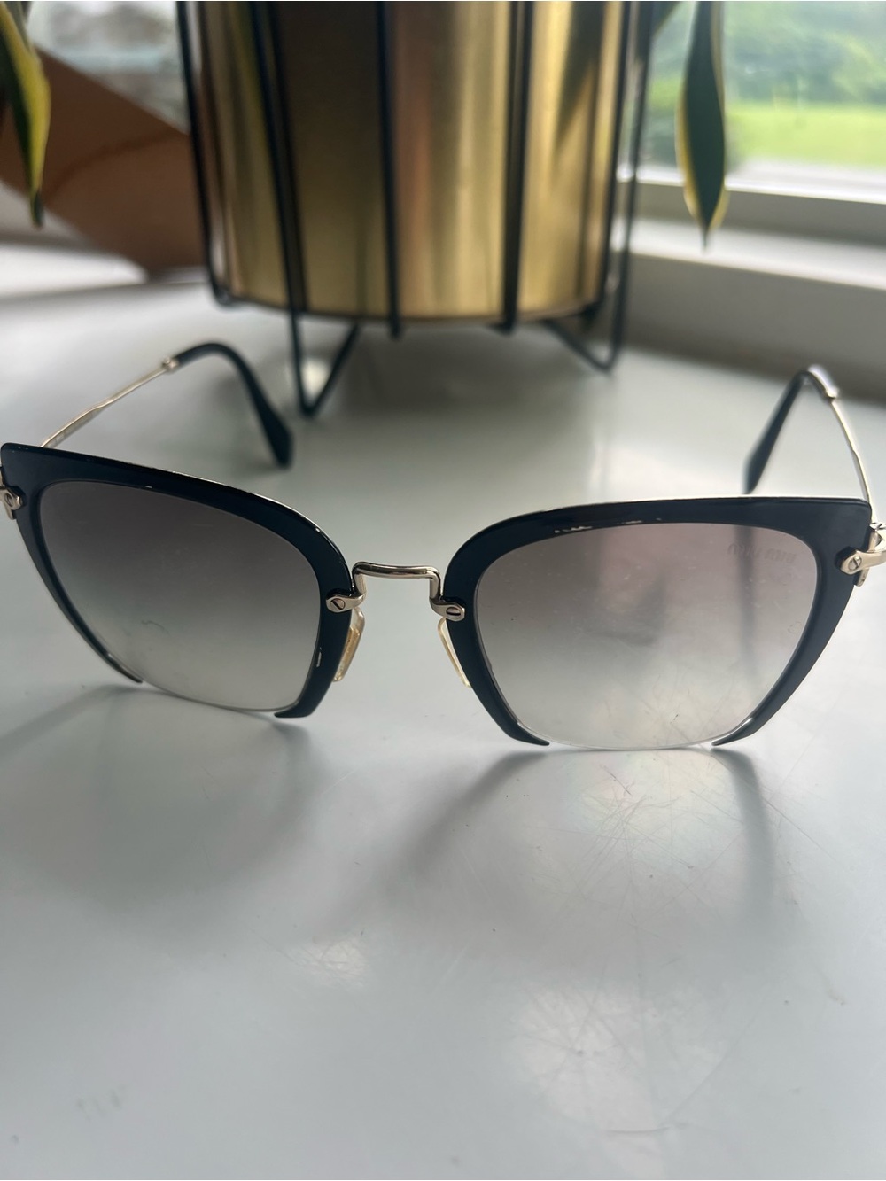 Miu Miu Black and Gold Cat-Eye Sunglasses with Gradient Smoke Lenses